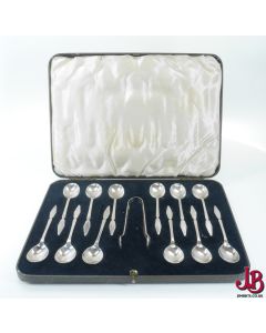 12 1940's vintage teaspoons and sugar tongs in a case - nice geometric design
