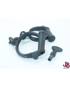 An old antique pair of Victorian HIATT iron police / prison handcuffs with ke